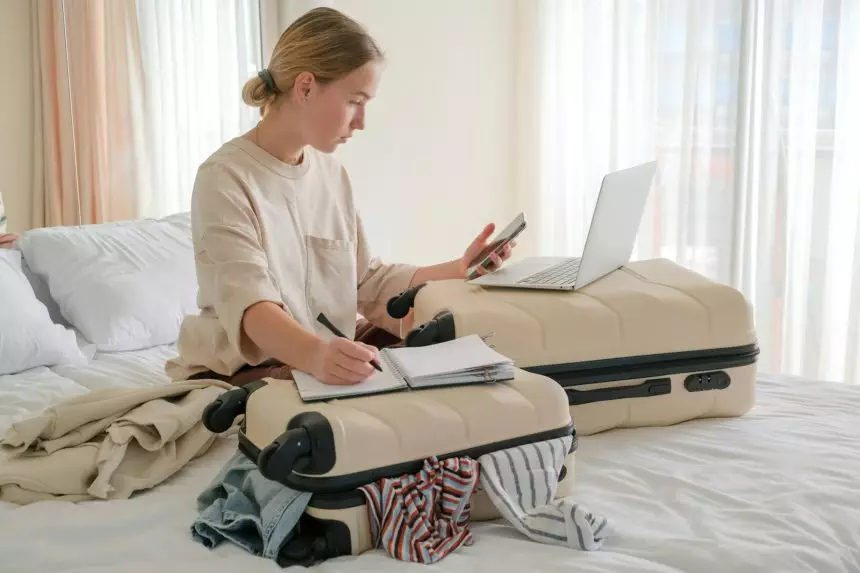 Travel.Suitcase.Girl traveler packing luggage in suitcase Travel,tourism,vacation,relocation.Mental